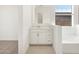 Bathroom featuring a tub and vanity with storage at 17672 W Pierson St, Goodyear, AZ 85395