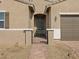 Close-up view of a charming front entrance with a secure gated entryway and brick walkway at 17672 W Pierson St, Goodyear, AZ 85395