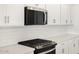 Close-up view of a modern kitchen with stainless steel appliances and white subway tile backsplash at 17672 W Pierson St, Goodyear, AZ 85395