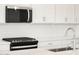 Close-up view of a modern kitchen with stainless steel appliances and white subway tile backsplash at 17672 W Pierson St, Goodyear, AZ 85395