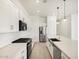 Modern white kitchen featuring an island, stainless steel appliances, and ample counter space at 17672 W Pierson St, Goodyear, AZ 85395