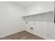 Laundry room with wood-look tile floor and shelves at 18350 W Poston Dr, Surprise, AZ 85387