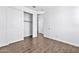 Bedroom with wood-look floors and double door closet at 27112 N 148Th Dr, Surprise, AZ 85387