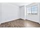 Bedroom with wood-look floors and large window with blinds at 27112 N 148Th Dr, Surprise, AZ 85387