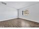 Simple bedroom with wood-look tile floors and mountain views at 27112 N 148Th Dr, Surprise, AZ 85387