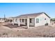 Rear view of house showcasing covered patio and desert landscaping at 27112 N 148Th Dr, Surprise, AZ 85387