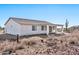 Rear view of house with covered patio and desert landscape at 27112 N 148Th Dr, Surprise, AZ 85387