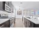 Modern kitchen with dark cabinets and white countertops at 27112 N 148Th Dr, Surprise, AZ 85387