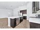 Modern kitchen with island and dark cabinetry at 27112 N 148Th Dr, Surprise, AZ 85387