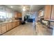 Kitchen with wood cabinets, tile countertops, and view to living room at 3155 S 127Th Ave, Avondale, AZ 85323