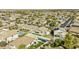 A wide aerial view of a neighborhood with lots of houses, green yards, and community pools at 43205 W Askew Dr, Maricopa, AZ 85138