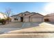 Tan three-car garage home with desert landscaping at 43205 W Askew Dr, Maricopa, AZ 85138