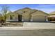 Inviting single-story home featuring a three-car garage and well-maintained landscaping at 43205 W Askew Dr, Maricopa, AZ 85138