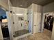 Walk-in shower featuring black fixtures and white tiled walls and a modern glass enclosure at 926 W Ayrshire Trl, San Tan Valley, AZ 85143