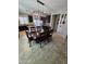 Open dining room showcasing a large table with seating for six underneath a modern chandelier at 926 W Ayrshire Trl, San Tan Valley, AZ 85143