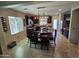 Open-concept kitchen with dark wood cabinetry, stainless steel appliances, and a dining area for Gathering meals at 926 W Ayrshire Trl, San Tan Valley, AZ 85143