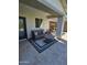 The patio contains outdoor furniture on top of a striped patio rug and travertine flooring at 926 W Ayrshire Trl, San Tan Valley, AZ 85143