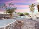 Backyard oasis with a sparkling pool, patio, and fire pit at 1342 N Mckenna Ln, Gilbert, AZ 85233