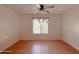 Well-lit bedroom with ceiling fan and hardwood floors at 1342 N Mckenna Ln, Gilbert, AZ 85233