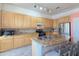 Modern kitchen with granite countertops and wood cabinets at 1342 N Mckenna Ln, Gilbert, AZ 85233