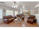 Comfortable living room with leather sofas and a view of the kitchen at 1342 N Mckenna Ln, Gilbert, AZ 85233