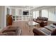 Living room with brown leather sofas and a large TV at 1342 N Mckenna Ln, Gilbert, AZ 85233