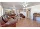 Spacious living room with leather furniture and kitchen access at 1342 N Mckenna Ln, Gilbert, AZ 85233