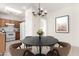 Cozy dining area with a round table and updated lighting fixture adjacent to the kitchen at 21067 N Sequoia Crest N Dr, Surprise, AZ 85387