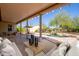 Covered patio overlooking a backyard oasis with pool and lush landscaping at 21067 N Sequoia Crest N Dr, Surprise, AZ 85387