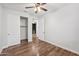 Well-lit bedroom featuring hardwood floors, a ceiling fan, and walk-in closet at 4360 N 186Th Ln, Goodyear, AZ 85395