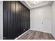 Modern entryway with black accent wall and wood-look floors at 4360 N 186Th Ln, Goodyear, AZ 85395