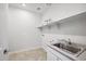 Bright laundry room with a sink and shelving at 4360 N 186Th Ln, Goodyear, AZ 85395