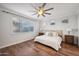 Main bedroom with hardwood floors, a large window and ceiling fan at 4360 N 186Th Ln, Goodyear, AZ 85395