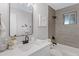 Updated bathroom featuring a modern vanity, stylish mirror, and shower-tub combo at 5232 E Dodge St, Mesa, AZ 85205