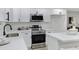 Bright kitchen with white cabinetry, quartz countertops, and stainless steel appliances at 5232 E Dodge St, Mesa, AZ 85205