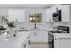 Modern kitchen featuring an island, white cabinets, quartz countertops and new appliances at 5232 E Dodge St, Mesa, AZ 85205