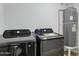 Modern laundry room featuring a Samsung washer and dryer with a nearby water heater at 5232 E Dodge St, Mesa, AZ 85205