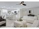 Open-concept living room featuring an island kitchen with white cabinets and modern appliances at 5232 E Dodge St, Mesa, AZ 85205