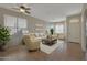 Bright living room featuring neutral tones, tile floors, lots of natural light, and stylish furnishings at 6520 W Oraibi Dr, Glendale, AZ 85308