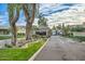 Gated community entrance with lush landscaping, mature trees, and elegant architecture at 8336 E Sunnyside Dr, Scottsdale, AZ 85260