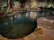 Night view of a freeform swimming pool with stone coping at 8336 E Sunnyside Dr, Scottsdale, AZ 85260