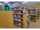 Community library with rows of bookshelves filled with books, offering a quiet reading space at 17200 W Bell Rd # 1015, Surprise, AZ 85374