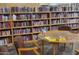 Cozy library area with bookshelves, a table with puzzle, and chairs, promoting community engagement at 17200 W Bell Rd # 1015, Surprise, AZ 85374