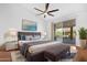 Main bedroom with sliding glass doors, ceiling fan, and plush bedding at 8546 E Brittle Bush Rd, Gold Canyon, AZ 85118