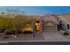 Single-story home with desert landscaping, two-car garage, and mountain views at 8546 E Brittle Bush Rd, Gold Canyon, AZ 85118