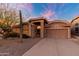 Single-story house with a two-car garage and desert landscaping at 8546 E Brittle Bush Rd, Gold Canyon, AZ 85118