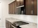 Modern kitchen with dark brown cabinets and granite countertops at 3650 E Alexander Dr, San Tan Valley, AZ 85143