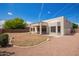 This backyard includes a patio and desert landscaping at 10101 E Posada Ave, Mesa, AZ 85212