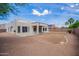 The home features a spacious backyard with a low-maintenance desert landscape at 10101 E Posada Ave, Mesa, AZ 85212