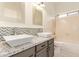 Bright bathroom featuring dual vanity sinks, granite counters, and stylish finishes at 10101 E Posada Ave, Mesa, AZ 85212
